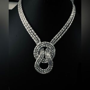 Silver tone, multi strand knot necklace.
